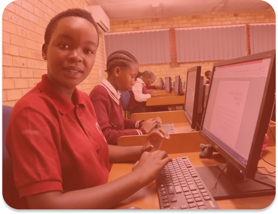 Students working on computers representing District Whole School Development Model Implementation