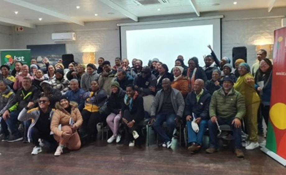 Group of people posing for a photo in an educational setting